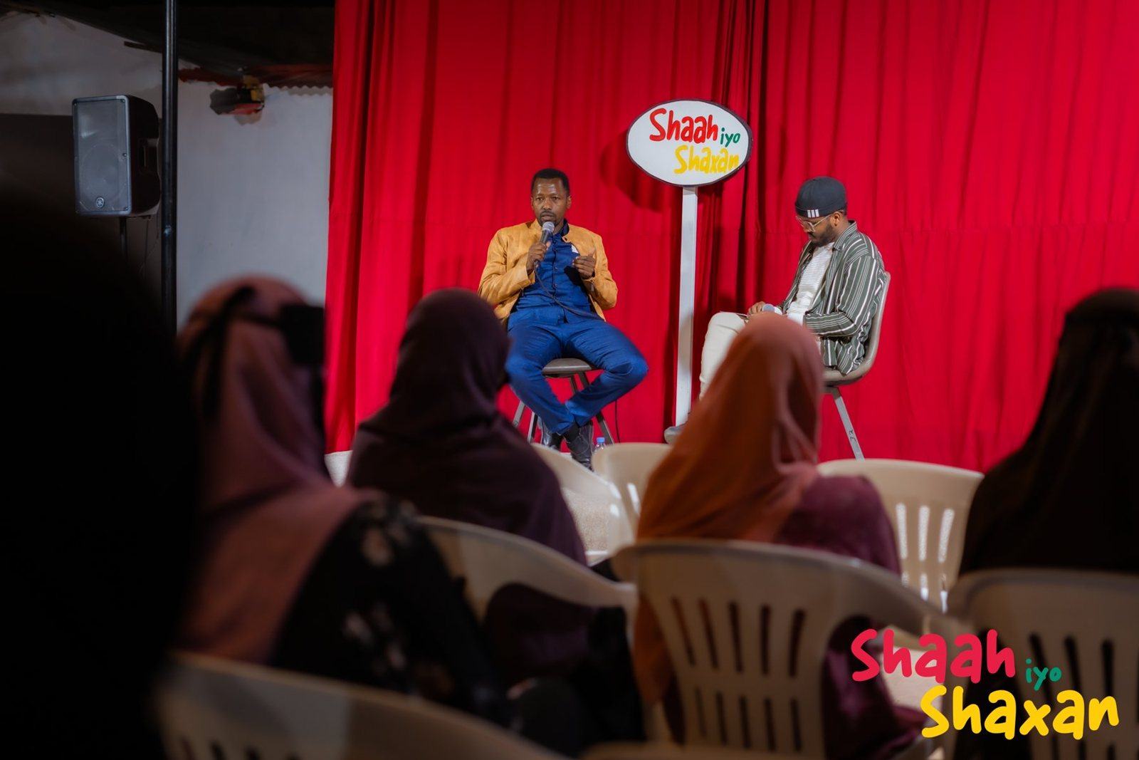 Guests on the red-curtain stage