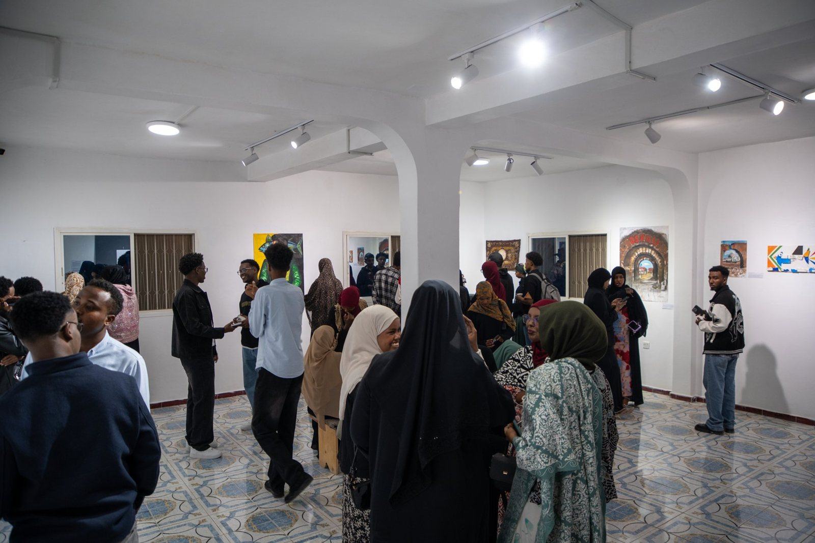 Visitors in the gallery at the Heer iyo Hiyikac exhibition
