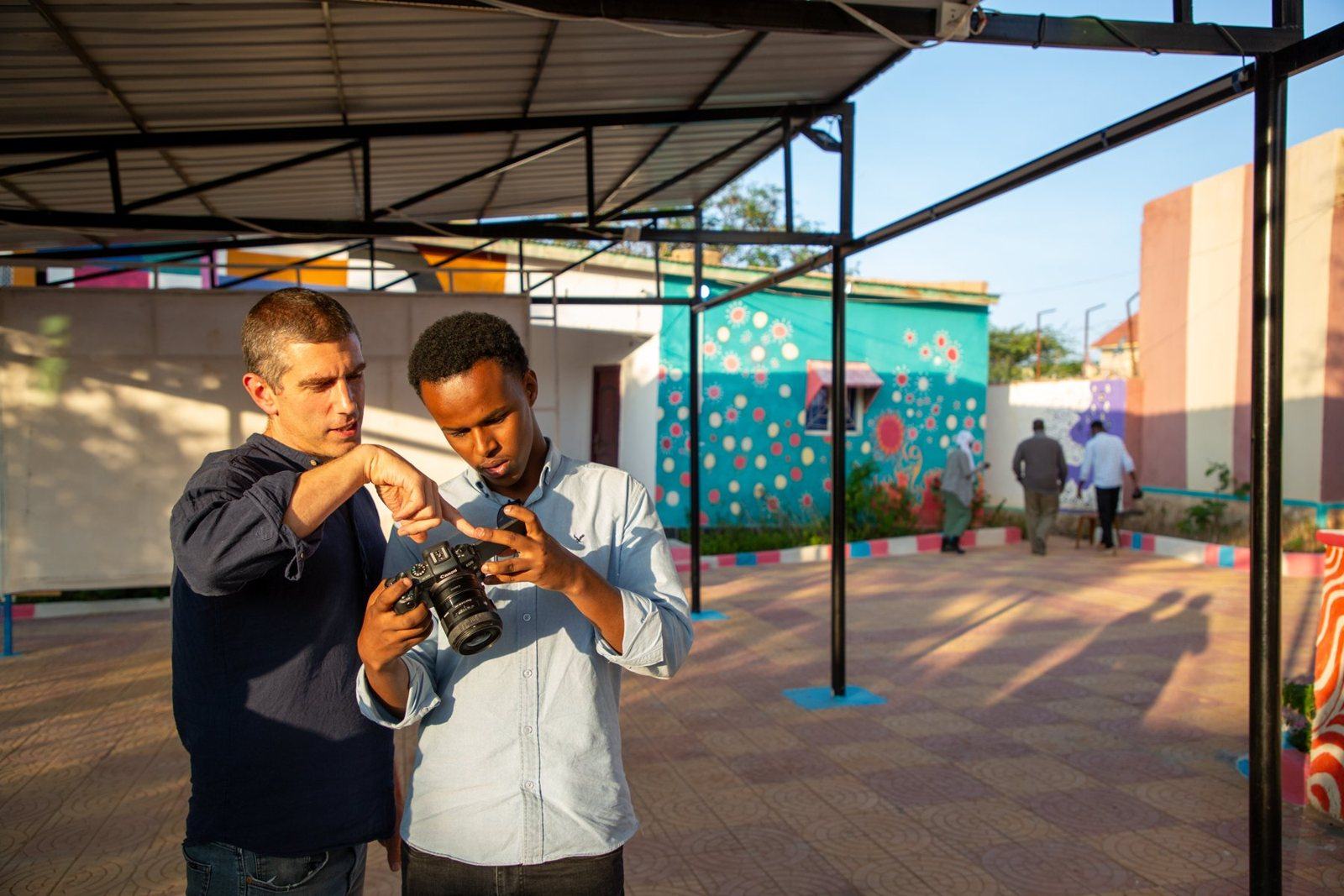 Young creatives filming with phones