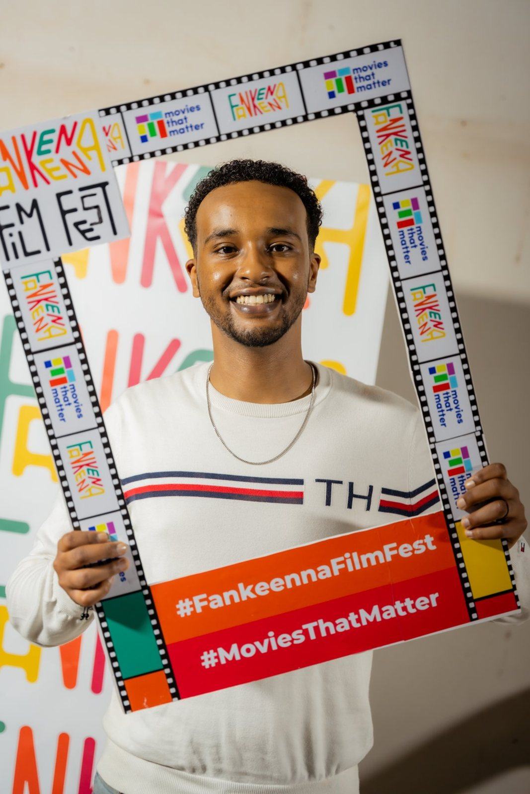 Young man holding the Fankeenna Film Fest frame
