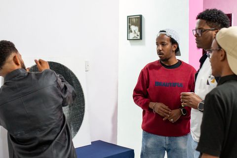 Visitors at the Isa Faysal string art exhibition