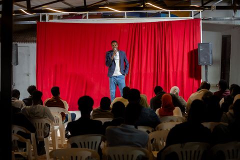 Performer on stage at the open mic