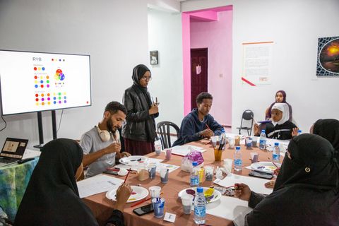 Participants painting at a visual art workshop